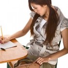 Asian schoolgirl is preparing to cheat on test