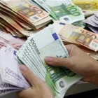 A bank employee counts Euro notes at Kasikornbank in Bangkok