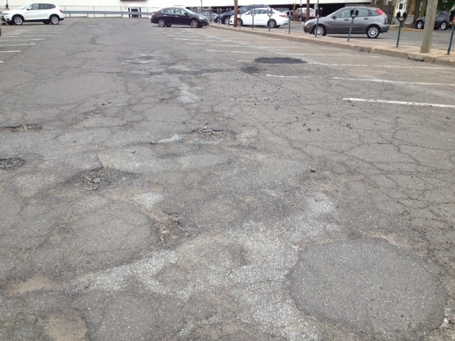 Pothole hazards at cottage place town parking lot