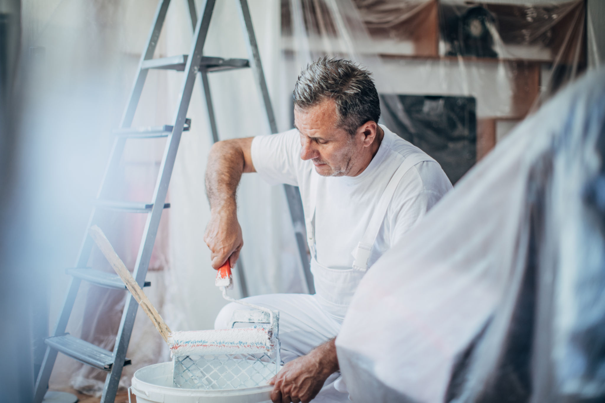 man ready to paint wall holding painting tools 384768305